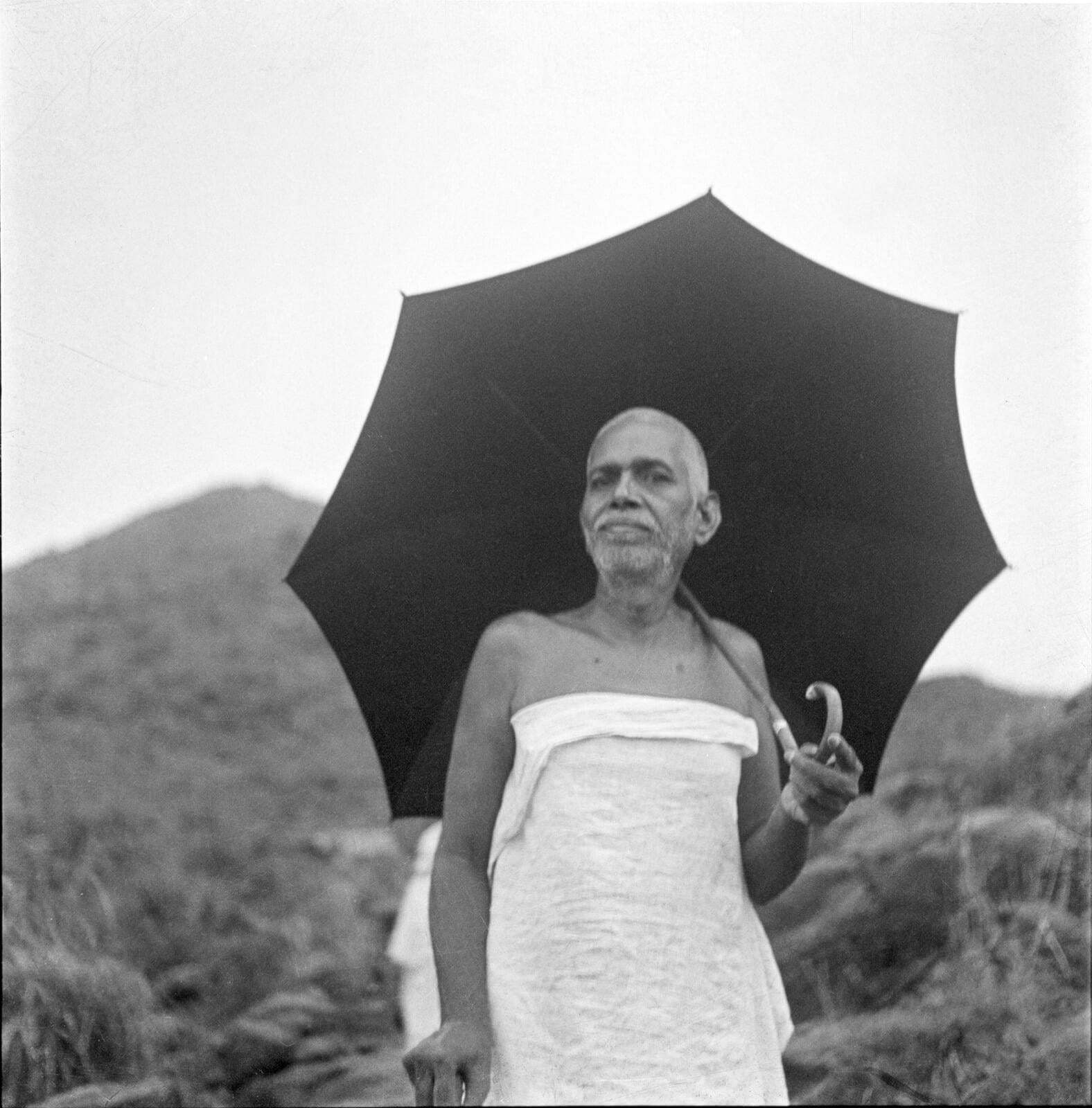 BOA_049_ac_standing-on-hill-holding-open-umbrella_1-of-3